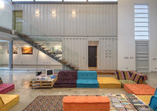 Trejos incorporated a variety of reused and recycled material into the project, such as shipping pallet tables, beds made from recyclyed plastic, and couches crafted in Costa Rica.