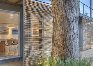Sliding bamboo panels on the west side of the house can be adjusted to provide shade during the later part of the day.