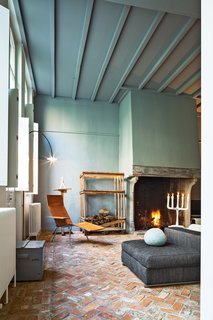 Wenes incorporated artful furnishings into the private spaces: In the living room, a leather chair by Maarten Van Severen is beneath a lamp by his son, Hannes Van Severen, of design duo Muller Van Severen.