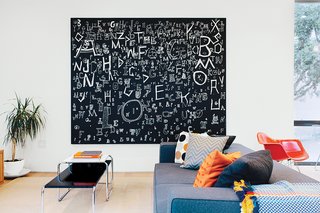 Architect George Bradley and his husband, Eddie Baba, renovated a 1941 house in San Francisco. A painting by Richard Wright and a sofa by Paolo Piva for B&B Italia dominate the family room.