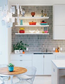 The space is just off the kitchen, which was moved and updated. Bradley paired cabinetry of his own design with tiles from Heath Ceramics.