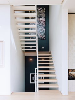Across from the entrance is the main staircase, which leads to the bedrooms.