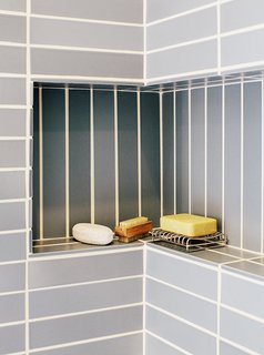 A shallow built-in bathroom shelf.