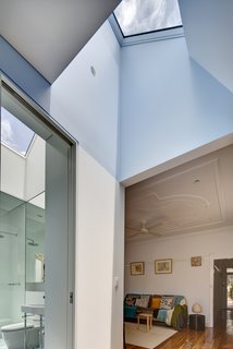 Save for a new fan and a coat of oil on its pine floors, the original living room remains unchanged. The master bathroom, however, has been completely refurbished with Scala accessories and a Duravit Happy D wall basin. Both rooms are brightened by skylights carved into the roof.
