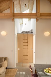 Two bedrooms flank a petite loft space, bringing the apartment's total sleeping spaces to three.