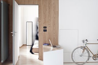 While R3 wanted to build a seemingly unbreakable space by utilizing heavy materials such as the zinc-coated pipes on the wall, the interior also offers built-in comforts, like the small table space and wraparound sofa built. Custom casework reduces clutter in the small space and humanizes the angular interior.