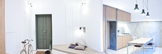 A panorama shows how highlights within the interior landscape define different sections of the apartment, almost a color-coded progression from work to dining to rest.