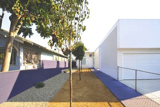Vibrant Affordable Housing Prototypes in Los Angeles - Photo 4 of 11 - The houses, like the 53rd Street Prototype, feature lean and gracious walkways to the front door. "Though these prototypes are set in economically challenged neighborhoods of South Los Angeles, their design provides for integrated defensible space while maintaining openness and connection to the outdoors," states the project description.