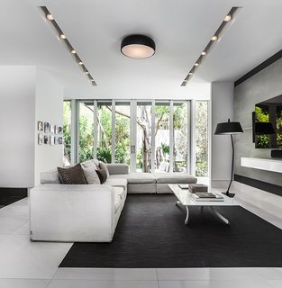 This Modern Miami House Feels Like It's in the Middle of the Jungle - Photo 6 of 12 - The interiors feature neutral, muted tones in order to highlight the views of the property.
