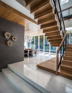 This Modern Miami House Feels Like It's in the Middle of the Jungle - Photo 7 of 12 - The ground level contains the living and dining spaces. Upstairs there are two bedrooms, plus the master suite.