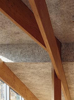 Wood-fiber cement panels by Koa Funen line the interior, and the criss-crossing laminated veneer lumber beams are from Key-Tec.