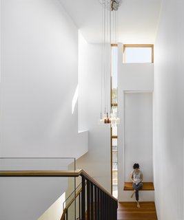 Smart Tech Makes this Modern Home Ultra Energy Efficient - Photo 5 of 11 - While the house is spread over two stories, Tedesco alotted space for an elevator, should the residents have mobility issues down the line. The pendants are Spillray by Axo and the windows are Loewen.