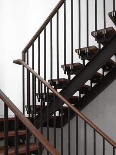 Smart Tech Makes this Modern Home Ultra Energy Efficient - Photo 6 of 11 - Tedesco's father was a precision machinist and his uncles worked as welders and carpentry framers. As a tribute to his family's history, Tedesco made the blackened-steel-and-wood staircase a focal point—it can be seen from nearly every room in the house.