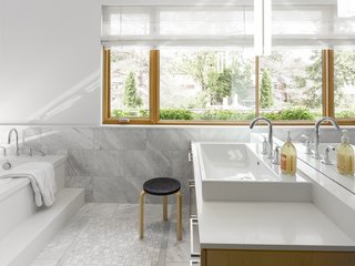 Smart Tech Makes this Modern Home Ultra Energy Efficient - Photo 7 of 11 - Carrara marble clads the spacious bathroom.