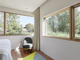 Smart Tech Makes this Modern Home Ultra Energy Efficient - Photo 8 of 11 - The structure has a 60/40 ratio of walls to windows, a figure that was achieved through computer modeling. "This ratio balances the amount of high R-value solid wall to glazing to create an overall building envelope for optimum thermal performance," Tedesco says. "This ratio was fine-tuned and tested using computer modeling that incorporated site-specific information such as building orientation, and the surrounding infrastructure such as neighboring houses and trees. The end result was an envelope design and window placement strategy that optimizes seasonal daylight cycles, maximizes solar gains in the winter, increases the level of interior natural daylighting, and considers views of the surrounding neighborhood." Because the residents are sensitive to noise, the walls feature extra insulaton, especially in the bedrooms and media rooms.