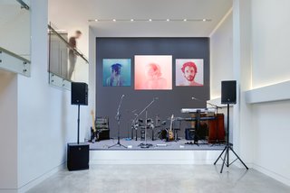 From a Flower Bulb Factory to an Entertainment Hub - Photo 6 of 9 - The owners host fundraising events throughout the year for a variety of local causes in the home’s public spaces. A double-height performance area is perfect for entertainment during these gatherings, during which local talent often performs. The artwork is by Jen Mann.
