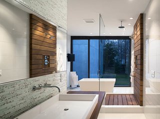 Inspired Indoor Teak Looks - Photo 14 of 14 - In the master bath, a custom raised Silestone sink is surrounded by a teak countertop and Porcelanosa glass tiles. Teak slats anchor the glass-enclosed shower.