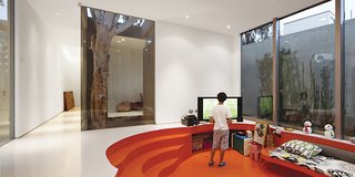 A Modern Concrete Home in Peru - Photo 11 of 13 - The sunken family room is enlivened by Alvarez-Calderón’s addition of fabrics from Designers Guild and glossy paint.