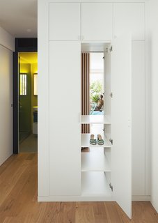 The cupboards in the guest bedroom are accessible from both that room and the hallway.