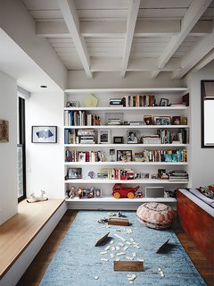 Brooklyn Home Keeps its Historic Bones While Getting a Much Needed Interior Update - Photo 2 of 13 - An ample sill made of English elm was built into two front windows to create a gathering spot that is visually connected to the street. Donna Wilson’s lively Ernest pouf in coral Nos Da upholstery for SCP adds extra seating in the living room.