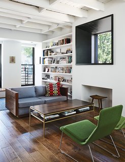 Brooklyn Home Keeps its Historic Bones While Getting a Much Needed Interior Update - Photo 4 of 13 - A vintage sofa purchased from Open Air Modern mixes with Low Pad chairs, by Jasper Morrison for Vitra, in the living room, which features a window inspired by Marcel Breuer’s Whitney Museum of American Art.