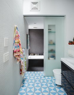 Brooklyn Home Keeps its Historic Bones While Getting a Much Needed Interior Update - Photo 7 of 13 - The second-floor bathroom includes a washroom that can be closed off from the bathing area with a sliding glass door. Bauer and Magid can supervise the kids’ baths or use it as a steam room.