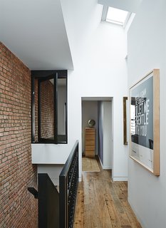 Brooklyn Home Keeps its Historic Bones While Getting a Much Needed Interior Update - Photo 9 of 13 - An interior window creates flow between the skylit landing and baby Banks’s room.