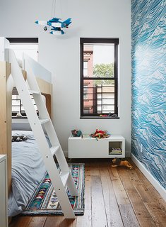 Brooklyn Home Keeps its Historic Bones While Getting a Much Needed Interior Update - Photo 10 of 13 - Magid selected lively Whitby wallpaper by Mini Moderns for Linus’s room, along with Oeuf’s Perch bunk bed. The homeowner found the light-up rocket-ship mobile on a trip to Mexico City.