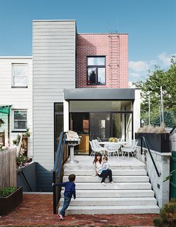 Brooklyn Home Keeps its Historic Bones While Getting a Much Needed Interior Update - Photo 11 of 13 - Floor-to-ceiling windows accentuate the home’s indoor-outdoor flow and connect the first-floor dining room to a patio. The vintage Russell Woodard dining set came from the Brooklyn Flea, and the Sterling II barbecueis by Tec.