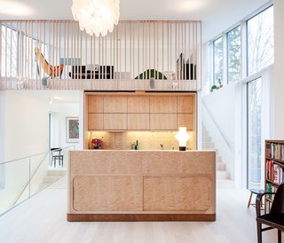 Carpenter Matti Salminen, a family friend, built the birch cabinets and island for the kitchen of a new home outside of Helsinki. The architect, Tuomas Siitonen, situated a lofted family room on the mezzanine above.