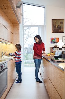 The kitchen is outfitted with a built-in refrigerator by Norcool and an AEG cooktop and oven.