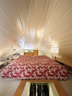 Tiny 1920s Garage Transformed Into a Charming Studio - Photo 8 of 8 - A triangular, open room beneath the gable roof provides a cozy space for sleeping. "The loft’s continuity increases the perceived size of the interior," Shaer says.