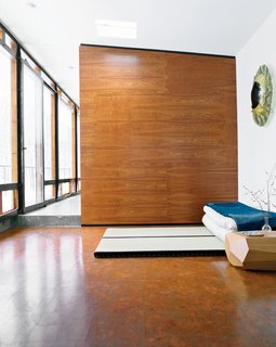 For one of two sleeping areas flanking the main living space, Wooten placed tatami from Miya Shoji on the cork floor. "With the radiant heating system, it’s fantastic to be in this glass box looking out at a blizzard, walking barefoot on the warm floor," he says. "Tatami are not for everyone, but they are really comfy to me. Before we built the house, I stayed at a traditional bed-and-breakfast in Kyoto, Japan, and had one of the best nights of sleep ever, so I decided I wanted to do that style of bed. On top is a 150-year-old Japanese denim patchwork quilt I bought from a friend who took me to Japan. I’ve always admired Japanese design—Noguchi is one of my favorites—so I was inspired to have that spirit in the house." miyashoji.com