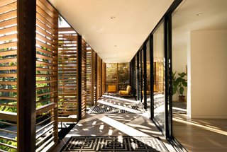 The shutter system creates a stunning interplay of light in the front patio space. At night, the shutters glow in the streetlight, "creating the sense of a magical Japanese tea house," according to resident Melissa Brillhart.