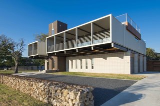The 40-foot-long containers hang 16 feet over the ground. The deep balcony, Gooden says, offers solar protection, keeping strong sunlight out but letting natural light in. The home has three bedrooms, a den, and three and half baths.