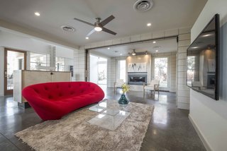 The 1,000-square-foot ground level is open. Three areas are divided gently by frames.