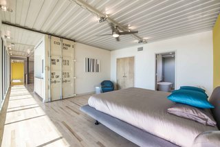 The container doors are used as barn-style sliding doors that open up to the bedrooms. The house has a "see-through nature," according to Gooden. It features a 66-foot unobstructed view along the window wall from one end to the other.
