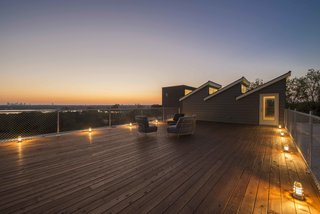 A 1400-square-foot roof deck offers panoramic views, overlooking White Rock Lake with one of the highest elevations in the city.