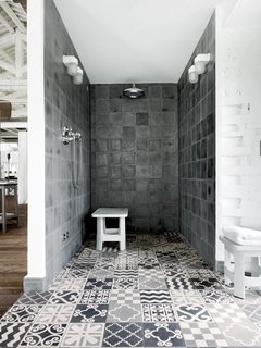 When Andrea Falkner-Campi and her husband commissioned Paola Navone to renovate an old tobacco factory in Spello, Italy, the Italian designer was even able to extend her chic industrial style to the bathroom with these custom-made Moroccan Carocim tiles that were used in the shower.