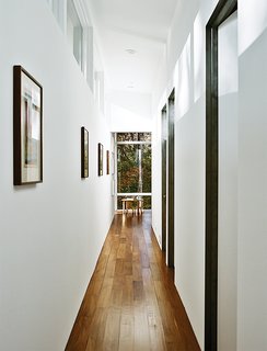 The interiors are painted in Sherwin-Williams Extra White Flat; flooring is five-inch walnut plank. A bentwood table and chairs are from ECR4Kids.