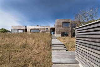 Exterior walls are clad in an sealed, unpainted western red cedar to mirror the colors of the site’s tawny meadows. As the wood ages naturally, it appears as though it emerged organically from the earth.