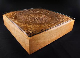 Mastering the Wood Grain - Photo 7 of 14 - EndGrain’s Ripple Coffee Table, shown here in cherry hardwood and glass, is a graphic representation of a the surface movement created by a ripple of water. Made up of cut squares of wood individually assembled back together, it is a good representation of the tension between natural and structure that often exists in Rupich’s work.