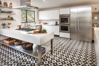 12 Creative Ways to Use Tile in Your Home - Photo 12 of 12 - The renovation of the kitchen added 100 square feet to the space, along with larger windows to let in more light. The appliances are Thermador, and the black-and-white floor tile by Granada Tile.