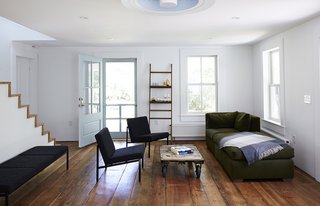 A bright, modern living area opens onto the porch.