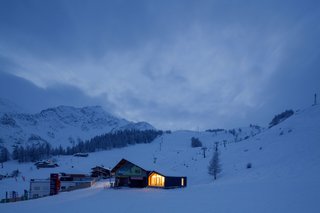 The Courmayeur Ski & Snowboard School's home is part of a cluster of buildings located in the ski area of Plan Checrouit, at the foot of Mont Blanc. LEAPfactory’s design for the facility, while crisp and contemporary, echoes the design of its neighbors, particularly their asymmetrical gables.