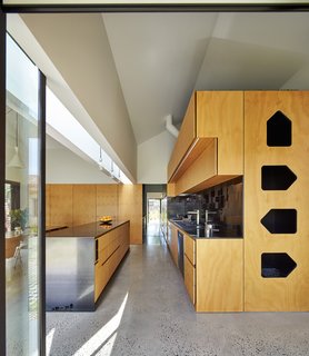 The house’s dominant gable form repeats at a smaller scale throughout the dwelling, as in the kitchen’s plywood and steel cabinets. "The gable became thematic throughout the process," Maynard explains. "Whenever issues arose, we referred back to it as a default, rather than adding a new idea." The sink is by Abey, faucet by Franke, and range by Qasair.