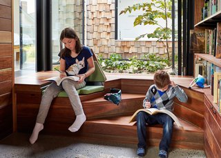 Responding to restrictions set by local planning authorities, the architects lowered the library’s floor level to preserve its cathedral ceilings. "We try to work with problems, not against them," Maynard says. "You now descend three steps into the studio and discover the desk at garden height, rather than above it." The solution also allowed for the installation of built-in reading nooks.
