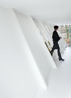 The original building’s structural framework is a series of sloping studs; Verschueren left these intact on the side of the house to be enlarged, matching them to new vertical studs in the frame constructed for the extension.