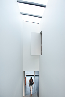 Inside, the architect began by re-thinking each interior space in non-traditional terms. The entryway, for example, is double-height, drawing attention to its narrowness. There is also an aperture to the upper floor, allowing more points of connection between the two levels.<br><br>"I wanted there to be an element of surprise, similarly to those experiences in Moroccan riads, where an unassuming door opens into another world," she says. "It was important for me to bring non-uniformity to my own house."