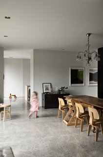 The 1920s Catalan chandelier and dining room table were both bought second-hand from a shop in Barcelona, where the family used to live. The table is the perfect place for the children to draw and play, "because it’s so old it doesn’t matter if it gets scratched," says Bergendy. "It’s technically a dining room with old-style wood panels, but the treatment is new — it’s not cutting edge, but the way the materials have been treated is different."